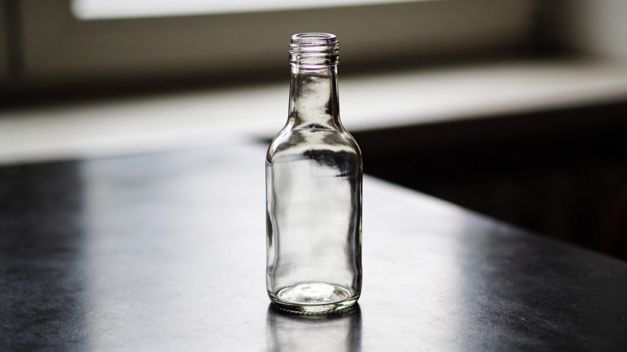 Glass bottle on a dark table